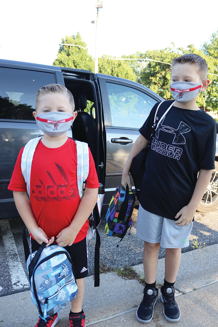 Creed and Ryder Newkirk hop out of the car Thursday for their first day of school at New Market Elementary.